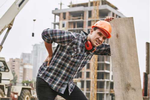 Construction worker with hurt back who needs Gainesville workers’ compensation lawyer